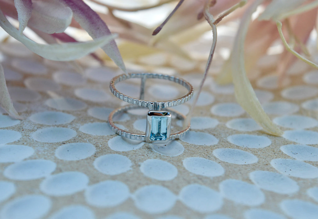 rhodium plated sterling silver natural blue topaz ring with double wide band