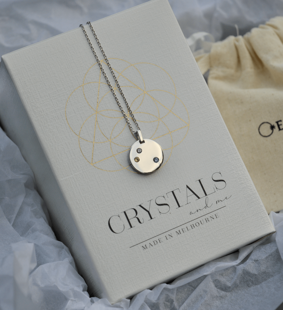 Symbolic gemstone necklace and crystal candle gift set